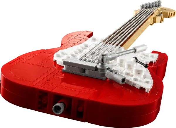 Create your own brick-built 1970s Fender® Stratocaster™ guitar and 65 Princeton® Reverb amplifier with this LEGO® Ideas set (21329). Recall the legendary musicians who have played a Stratocaster® as you recreate its iconic curves and add authentic details such as the posable whammy bar, pickup switch and tuning pegs. The buildable amp has removable panels for easy viewing of the motherboard, reverb tank, speaker and other interior details, plus rubber cables to connect it to the guitar and footswitch. Striking centerpiece This set includes bricks to build the guitar in either red or black, guitar picks in 4 colors and an elegant, foldable stand for the guitar model to complete a delightful display piece. There is also a sticker with the Fender logo made from LEGO bricks for you to attach to your real guitar or amp. Cool collectible This building kit is part of a collection of LEGO sets for adults. It’s a top gift idea for guitar players, Fender fans, music lovers and keen LEGO builders. Recreate a legendary guitar with this wonderfully detailed LEGO® Ideas build-and-display model (21329) of a 1970s Fender® Stratocaster® guitar and a buildable Fender 65 Princeton® Reverb amplifier. The guitar features a posable whammy bar, pickup switch and tuning pegs, six strings, Fender® logo stickers, and a textile strap. The bricks included let you build the guitar in red or black. The amplifier has removable panels for easy viewing of the motherboard, reverb tank, speaker and other interior details, logo stickers, plus connecting rubber cables for the guitar and footswitch. Includes a foldable display stand for the guitar, model-scale guitar picks in 4 colors, plus a sticker of the Fender® logo built from LEGO® bricks to put on your real guitar, amp or wherever you want. Guitar measures over 14 in. (36 cm) long, 4 in. (11 cm) wide and 1 in. (3 cm) deep. This LEGO® display model makes a cool gift for guitar players, music lovers and Fender® Stratocaster® guitar fans. Fun to build solo or with friends and family to share your love of this iconic guitar, music and/or building with LEGO® bricks. This 1,079-piece set comes with a booklet about the history of the Fender® Stratocaster® guitar, the set’s fan designer and LEGO® designers, plus step-by-step instructions for a joyful build. This cool building set was entered in the LEGO® Ideas ‘Music to our Ears’ contest by a fan designer and chosen from the top 9 entries to become the next LEGO Ideas set by the LEGO Ideas review board. LEGO® components meet stringent industry standards to ensure simple, secure connections and robust builds. It’s been that way since 1958. LEGO® building bricks and pieces are tested in almost every way imaginable to ensure that every LEGO set satisfies rigorous global safety standards.