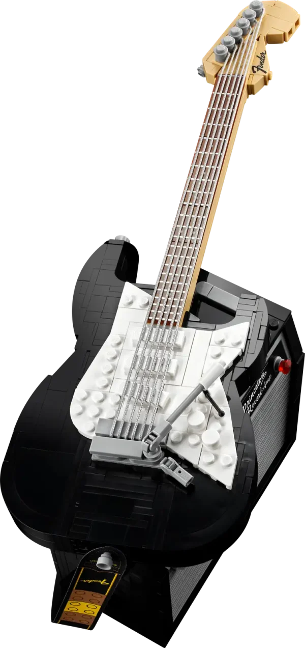 Create your own brick-built 1970s Fender® Stratocaster™ guitar and 65 Princeton® Reverb amplifier with this LEGO® Ideas set (21329). Recall the legendary musicians who have played a Stratocaster® as you recreate its iconic curves and add authentic details such as the posable whammy bar, pickup switch and tuning pegs. The buildable amp has removable panels for easy viewing of the motherboard, reverb tank, speaker and other interior details, plus rubber cables to connect it to the guitar and footswitch. Striking centerpiece This set includes bricks to build the guitar in either red or black, guitar picks in 4 colors and an elegant, foldable stand for the guitar model to complete a delightful display piece. There is also a sticker with the Fender logo made from LEGO bricks for you to attach to your real guitar or amp. Cool collectible This building kit is part of a collection of LEGO sets for adults. It’s a top gift idea for guitar players, Fender fans, music lovers and keen LEGO builders. Recreate a legendary guitar with this wonderfully detailed LEGO® Ideas build-and-display model (21329) of a 1970s Fender® Stratocaster® guitar and a buildable Fender 65 Princeton® Reverb amplifier. The guitar features a posable whammy bar, pickup switch and tuning pegs, six strings, Fender® logo stickers, and a textile strap. The bricks included let you build the guitar in red or black. The amplifier has removable panels for easy viewing of the motherboard, reverb tank, speaker and other interior details, logo stickers, plus connecting rubber cables for the guitar and footswitch. Includes a foldable display stand for the guitar, model-scale guitar picks in 4 colors, plus a sticker of the Fender® logo built from LEGO® bricks to put on your real guitar, amp or wherever you want. Guitar measures over 14 in. (36 cm) long, 4 in. (11 cm) wide and 1 in. (3 cm) deep. This LEGO® display model makes a cool gift for guitar players, music lovers and Fender® Stratocaster® guitar fans. Fun to build solo or with friends and family to share your love of this iconic guitar, music and/or building with LEGO® bricks. This 1,079-piece set comes with a booklet about the history of the Fender® Stratocaster® guitar, the set’s fan designer and LEGO® designers, plus step-by-step instructions for a joyful build. This cool building set was entered in the LEGO® Ideas ‘Music to our Ears’ contest by a fan designer and chosen from the top 9 entries to become the next LEGO Ideas set by the LEGO Ideas review board. LEGO® components meet stringent industry standards to ensure simple, secure connections and robust builds. It’s been that way since 1958. LEGO® building bricks and pieces are tested in almost every way imaginable to ensure that every LEGO set satisfies rigorous global safety standards.