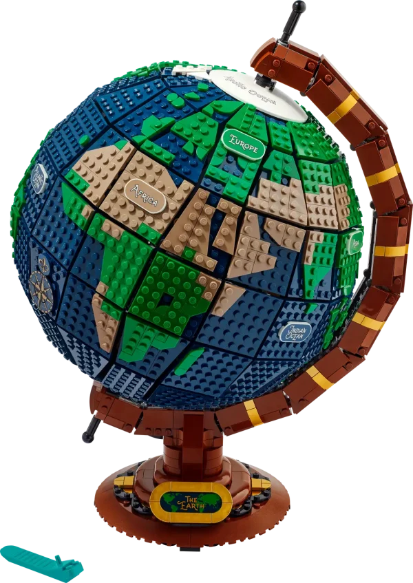 Where do you want to go today? Dream of your next travel destination as you build The Globe (21332). Created by a fan-designer and brought to the world by the LEGO® Ideas team, this display model recreates the spinning movement of a vintage Earth globe with the help of LEGO Technic™ elements and features glow-in-the-dark tiles decorated with the names of continents and oceans. There are buildable ship and compass icons, plus ‘The Earth’ nameplate to complete a charming centerpiece to enhance the decor of any home or office. Travel without moving A journey of 2,585 pieces starts with a single brick, and illustrated instructions are included to guide every step of your building adventure. This collectible model makes the best gift for yourself or travel-loving friends. Unplug, unbox and unwind Welcome to LEGO sets for adults – a zone of zen for focused, hands-on creative building. From the wonders of the world to movie magic, pop culture icons and more, there is a LEGO set waiting for you. Spinning Earth globe model for display – Explore the world as you build this The Globe (21332) set, a detailed LEGO® Ideas replica of a vintage Earth globe Authentic spinning movement – Two LEGO® worlds collide to build this globe, with LEGO Technic™ elements to recreate the classic, spinning axis and LEGO System bricks to replicate the spherical shape Glow-in-the-dark decoration – Light up the room with decorated tiles displaying the names of continents and oceans Buildable ship and compass icons – Build vintage-style ship and compass icons to attach to the globe, and affix ‘The Earth’ nameplate to the base for a finishing touch Gift idea for adults – Treat yourself or give this 2,585-piece LEGO® Earth globe model as a birthday, holiday or surprise gift for someone passionate about travel, geography, arts or decoration Buildable home or office decor – This display piece measures over 16 in. (40 cm) high, 11.5 in. (30 cm) wide and 10 in. (26 cm) deep Step-by-step guide – Includes an illustrated booklet featuring the set’s fan designer and LEGO® designers, plus illustrated instructions to guide your hands-on, mind-on building experience The LEGO® fans’ choice – This construction model for adults is one of many LEGO Ideas sets, each created by a fan designer, voted for by LEGO fans and produced by the LEGO Group Premium quality, no compromises – Since 1958, LEGO® bricks have met strict industry quality standards to ensure that they connect simply and securely Safety assurance – LEGO® components are dropped, heated, crushed, twisted and carefully analyzed to make sure that they meet rigorous global safety standards