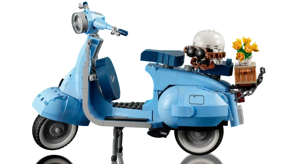 Dive into a mindful building project packed with style with this LEGO® Vespa 125 model kit for adults. Inspired by the classic 1960s Vespa Piaggio, it comes in pastel blue – a very rare LEGO color that’s sure to appeal to building fans. To celebrate Vespa’s 75th anniversary, the LEGO designers have worked closely with the lifestyle brand to recreate this stunning model in an immersive build, especially for adults. Beautiful details. Authentic features Like the original, this buildable model Vespa features a front wheel mounted on one side, 2 seats, a removable engine cover with a brick-built engine beneath, a functioning kickstand, plus working steering. Finishing touches include the Vespa logo, a classic 1960s Italian license plate, a spare wheel, a helmet, plus an accessories basket including a flower bouquet on the back. Welcome to your zone Build creativity. Build concentration. Build your dream vehicle collection with exclusive, authentic model vehicles, made specifically for adults. Assemble your own LEGO® Vespa 125 – Build a detailed displayable model of an Italian icon with this building set (10298) for adults Inspired by the original – This brick-built Vespa features a front wheel mounted on one side, 2 seats, a removable engine cover with a brick-built engine underneath, and working steering Extra details – Finishing touches include the Vespa logo, a classic 1960s Italian license plate, a spare wheel, helmet and an accessories basket with flower bouquet Designed for Vespa fans – To celebrate Vespa’s 75th anniversary, the LEGO® designers have worked with the lifestyle brand to create a model to appeal to lovers of Italian culture A rare color – Presented in pastel blue, one of the Vespa’s original production colors and an extremely rare LEGO® color designed to appeal to LEGO fans Celebrate La Dolce Vita – With its functioning kickstand, this model can be placed on display in the home or office to create your own tribute to Vespa Dimensions – This collectible display model measures over over 8.5 in. (22 cm) high, 13.5 in. (35 cm) long and 4.5 in. (12 cm) wide A project for adults – This LEGO® set is part of a range of building sets designed for adult building fans and makes a gift idea for Vespa fans Quality materials – LEGO® building bricks are manufactured from high-quality materials. They’re consistent, compatible and connect and pull apart easily every time: it’s been that way since 1958 Safety ensured – With LEGO® pieces, safety and quality come first. That’s why they’re rigorously tested so you can be sure that this Vespa model kit is robust