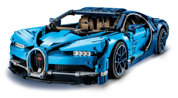 Explore engineering excellence with the LEGO® Technic™ 42083 Bugatti Chiron advanced building set. This exclusive model has been developed in partnership with Bugatti Automobiles S.A.S to capture the essence of the quintessential super sports car, and comes with gleaming aerodynamic bodywork, logoed spoked rims with low-profile tires, and detailed brake discs. The accessible cockpit features a Technic 8-speed gearbox with movable paddle gearshift and a steering wheel bearing the Bugatti emblem. Insert the top speed key and you can switch the active rear wing from handling to top speed position. The rear lid affords a glimpse of the detailed W16 engine with moving pistons, while beneath the hood you’ll discover a unique serial number and a compact storage compartment containing a stylish Bugatti overnight bag. This 1:8 scale model comes with a classic Bugatti duo-tone blue color scheme that reflects the brand's signature color, and a set of stickers for additional detailing. The set is delivered in luxurious box packaging and includes a color collector’s booklet with comprehensive building instructions. Exclusive 1:8 scale LEGO® Bugatti Chiron replica model with a wealth of luxurious features, including aerodynamic bodywork with an active rear wing, logoed spoked rims with low-profile tires, detailed brake discs and a W16 engine with moving pistons. Open the doors to access the detailed cockpit featuring a LEGO® Technic™ 8-speed gearbox with movable paddle gearshift and a steering wheel bearing the Bugatti emblem. Insert the top speed key to switch the active rear wing from handling to top speed position. Lift the hood to access a compact storage compartment containing a stylish Bugatti overnight bag. Check out the detailed W16 engine with moving pistons. Includes a unique serial number located beneath the hood. Comes with a classic Bugatti duo-tone blue color scheme that reflects the brand's signature color, plus a set of cool stickers for additional detailing. Delivered in luxurious box packaging. Includes a color collector's booklet with comprehensive building instructions. This LEGO® Technic™ model is designed to provide an immersive and rewarding building experience. This set includes 3,599 pieces. Suitable for ages 16+. Bugatti Chiron measures over 5” (14cm) high, 22” (56cm) long and 12.5”(32cm) wide.