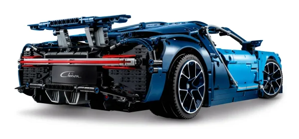 Explore engineering excellence with the LEGO® Technic™ 42083 Bugatti Chiron advanced building set. This exclusive model has been developed in partnership with Bugatti Automobiles S.A.S to capture the essence of the quintessential super sports car, and comes with gleaming aerodynamic bodywork, logoed spoked rims with low-profile tires, and detailed brake discs. The accessible cockpit features a Technic 8-speed gearbox with movable paddle gearshift and a steering wheel bearing the Bugatti emblem. Insert the top speed key and you can switch the active rear wing from handling to top speed position. The rear lid affords a glimpse of the detailed W16 engine with moving pistons, while beneath the hood you’ll discover a unique serial number and a compact storage compartment containing a stylish Bugatti overnight bag. This 1:8 scale model comes with a classic Bugatti duo-tone blue color scheme that reflects the brand's signature color, and a set of stickers for additional detailing. The set is delivered in luxurious box packaging and includes a color collector’s booklet with comprehensive building instructions. Exclusive 1:8 scale LEGO® Bugatti Chiron replica model with a wealth of luxurious features, including aerodynamic bodywork with an active rear wing, logoed spoked rims with low-profile tires, detailed brake discs and a W16 engine with moving pistons. Open the doors to access the detailed cockpit featuring a LEGO® Technic™ 8-speed gearbox with movable paddle gearshift and a steering wheel bearing the Bugatti emblem. Insert the top speed key to switch the active rear wing from handling to top speed position. Lift the hood to access a compact storage compartment containing a stylish Bugatti overnight bag. Check out the detailed W16 engine with moving pistons. Includes a unique serial number located beneath the hood. Comes with a classic Bugatti duo-tone blue color scheme that reflects the brand's signature color, plus a set of cool stickers for additional detailing. Delivered in luxurious box packaging. Includes a color collector's booklet with comprehensive building instructions. This LEGO® Technic™ model is designed to provide an immersive and rewarding building experience. This set includes 3,599 pieces. Suitable for ages 16+. Bugatti Chiron measures over 5” (14cm) high, 22” (56cm) long and 12.5”(32cm) wide.