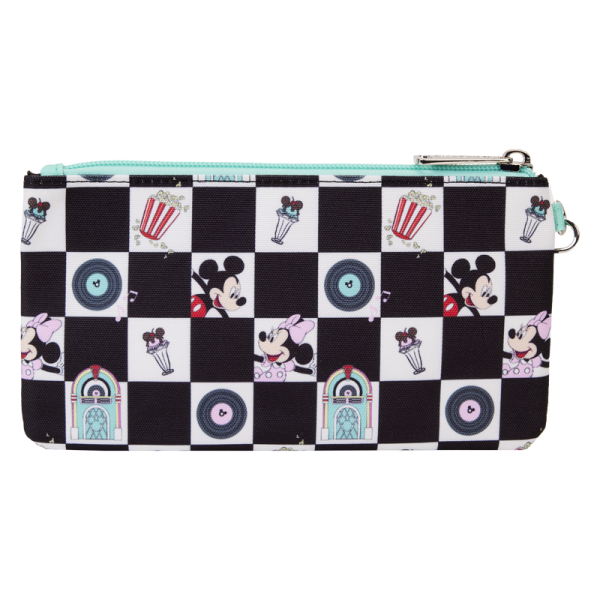 Select a song from the jukebox and prepare to dance! Our Loungefly Disney Mickey Mouse and Minnie Mouse Date Night Diner All-Over-Print Nylon Wristlet is ready for fun. This accessory features an all-over black-and-white checkered pattern, reminiscent of a dance floor in a 1950s diner. Inside the white checker boxes, you’ll find printed images of records, jukeboxes, Disney’s Mickey Mouse and Minnie Mouse, popcorn, and ice cream sundaes. Accents of teal add a retro pop of color. When you open the wallet, there are approximately four slots for holding cards and securing valuables. Bring your plus one, and this wallet, to kick up your heels in style. The Loungefly Disney Mickey Mouse and Minnie Mouse Date Night Diner All-Over-Print Nylon Wristlet is made of nylon. Wallet zips closed with silver-colored metal hardware. Additional features include printed details. Take note of the inside lining with the Loungefly logo. This wallet is an officially licensed Disney product. Wallet dimensions: 7”W x 4.5”H