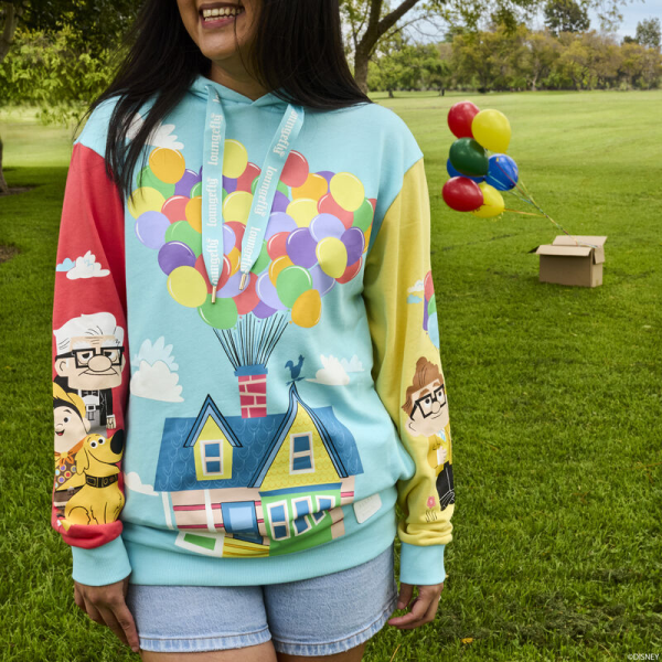 Up, up, and away! Let your adventures take flight with the Loungefly Disney-Pixar Up 15th Anniversary Unisex Hoodie. On the front, Carl and Ellie’s house floats through the sky with the help of colorful balloons. Pockets appear on each side of the sweatshirt, giving you space to store your belongings. On one sleeve, a young Carl and Ellie drift on a bouquet of balloons. On the other, Carl stands with Russel and Dug. Extra-large drawcords cinch together the hood, which features an all-over printed lining of clouds and balloons. This comfortable hoodie makes a heartwarming addition to any outfit and will keep you looking stylish on all your travels. The Loungefly Disney-Pixar Up 15th Anniversary Unisex Hoodie is made of French Terry cotton (60% cotton, 40% polyester). Extra-large lanyard-style drawcords add versatility in wear and fit and are perfect for displaying your favorite pins. Cuffs and waistband are 95% cotton and 5% spandex. This hoodie is an officially licensed Disney-Pixar product. Comes in unisex sizes S through 3X.