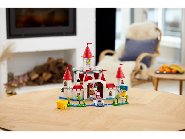 Let kids add an iconic location to their LEGO® Super Mario™ universe with the Peach’s Castle Expansion Set (71408). There is so much for players to explore and many ways to earn digital coins with their interactive LEGO® Mario™, LEGO® Luigi™ or LEGO® Peach™ figures (not included). It features a throne room with a spinning wall to reveal Bowser, Peach stained-glass window, a Bob-omb painting with an Action Tag, cake with a Goomba hiding inside, Special Pipe: Peach’s Castle, Time Block, ‘broken’ bridge, fruit bowl with a purple fruit and more. (Note: the 71360, 71387 or 71403 Starter Course is required for interactive play.) Share the fun A top gift for kids aged 8 and up, this toy playset includes 5 Super Mario™ characters and is ideal for solo or social play. Download the LEGO Super Mario app for building instructions. Unlimited levels LEGO Super Mario Starter Courses and Expansion Sets, allow fans to expand, rebuild and create their own levels for hours of coin-collecting play. Highly detailed Peach’s Castle (71408) – Children can add an iconic location to their LEGO® Super Mario™ world with this challenge-packed Expansion Set 5 LEGO® Super Mario™ toy figures – Bowser, Ludwig, Toadette, a Goomba and a Bob-omb Authentic features – A Special Pipe: Peach’s Castle, Time Block, Peach stained-glass window, Bob-omb painting with a hidden Action Tag, cake with a Goomba hiding inside, a purple fruit and more Throne room – Help LEGO® Mario™, LEGO® Luigi™ or LEGO® Peach™ (figures not included) activate the slider platform to spin the wall and reveal Bowser, then jump on the triggers to flip him over Gift for ages 8 and up – Give this 1,216-piece set as a birthday or holiday gift to trendsetting kids who own a LEGO® Super Mario™ Starter Course (71360, 71387 or 71403), which is required for play Rebuild and mix – Measuring over 11.5 in. (30 cm) high, 14 in. (36 cm) wide and 18.5 in. (48cm) deep in its basic formation, this modular set can be combined with other LEGO® Super Mario™ sets Digital instructions – Download the LEGO® Super Mario™ app for building instructions, creative inspiration and more. For a list of compatible Android and iOS devices, visit LEGO.com/devicecheck Endless possibilities – Collectible LEGO® Super Mario™ toy playsets are designed for solo or social play, offering coin-collecting fun and unlimited challenges through expansion and rebuilding Premium quality – LEGO® components meet demanding industry quality standards to ensure that they connect simply and securely for robust builds Safety first – LEGO® bricks and pieces are dropped, heated, crushed, twisted and analyzed to ensure that they satisfy rigorous global safety standards