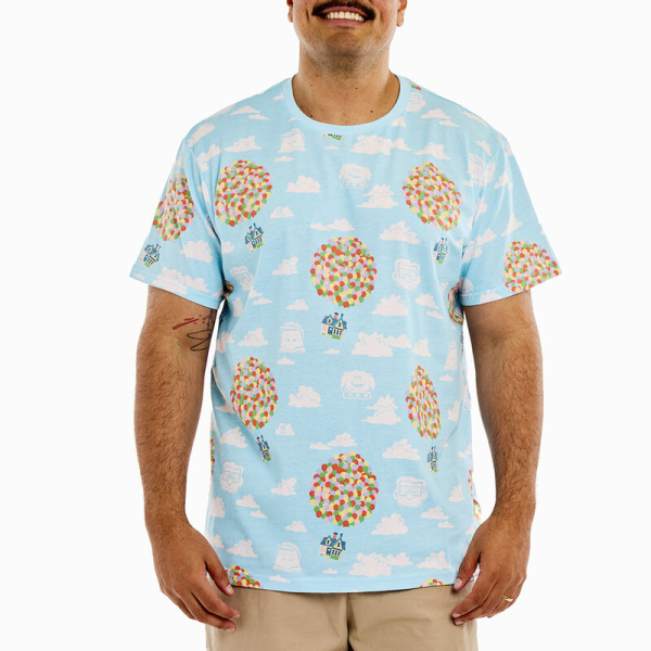 Up, up, and away! Let your adventures take flight with the Loungefly Disney-Pixar Up 15th Anniversary Balloon House Unisex Tee. This sky blue tee shirt features an all-over print of Carl and Ellie’s house as it floats through the clouds. Large bunches of colorful balloons give the house an extra lift, and some of the film’s characters take shape in the clouds. Look closely, and you’ll see Carl, Russel, and Dug, along with a 15th-anniversary logo! This comfortable tee shirt makes a heartwarming addition to any outfit and will keep you looking stylish on all your travels. The Loungefly Disney-Pixar Up 15th Anniversary Balloon House Unisex Tee is made of super soft 100% cotton jersey material. Please note: Patterns will vary with all-over print styles. Not every piece will look identical nor will every piece be an exact match as to what is pictured online. This tee is an officially licensed Disney-Pixar product. Comes in unisex sizes S through 3X. Sizing is very specific, so please consult the size chart before purchasing.