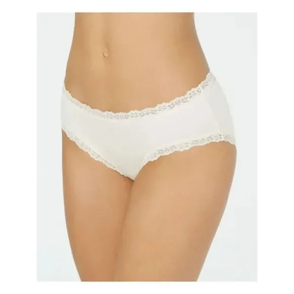 Add a playful twist to your everyday essentials with the Jenni Women's Whimsy Dot Bikini in Bright White. This bikini-style underwear combines classic comfort with a fun, whimsical design, making it a delightful addition to any lingerie collection. Features: Bright White with Whimsy Dots: A crisp bright white background is adorned with charming dots, adding a playful and fresh look to your lingerie drawer. Bikini Cut: The classic bikini cut offers moderate coverage and sits comfortably on the hips, providing a flattering and secure fit for daily wear. Soft and Breathable Fabric: Made from a premium cotton blend, this bikini ensures softness and breathability, keeping you comfortable throughout the day. Comfortable Waistband: The elastic waistband is designed to stay in place without digging into the skin, ensuring a comfortable fit that moves with you. Smooth Silhouette: Designed to minimize visible panty lines, this bikini offers a smooth and seamless look under clothing, perfect for any outfit. Material: Body: 93% Cotton, 7% Spandex Care Instructions: Machine wash cold with similar colors Use only non-chlorine bleach when needed Tumble dry low Do not iron