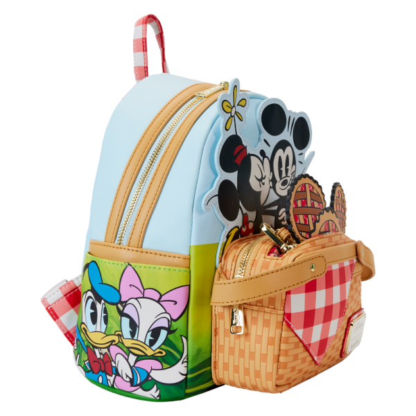 Life’s a picnic when you’re with your pals! Spend a sunny day in the countryside with the Loungefly Mickey and Friends Picnic Mini Backpack. On the front, a woven picnic basket takes shape on the bag’s zipper pocket. Look inside the basket to find a Mickey-shaped pie, which doubles as a strawberry-scented coin bag! Minnie and Mickey appear up above while Donald, Daisy, and Goofy join the fun on the bag’s side pockets. On the back, gingham shoulder straps accompany Pluto as he sizes up a tasty feast. This mini backpack makes a stylish addition to any outing and has plenty of room to pack your picnic essentials. The Loungefly Mickey and Friends Picnic Mini Backpack is made of vegan leather (polyurethane). Bag has adjustable shoulder straps, removeable coin bag (polyurethane), and shiny gold hardware. Additional features include applique, debossed, scented, and printed details. Take note of the coordinating inside lining. This backpack is an officially licensed Disney product. Backpack dimensions: 9”W x 10.5”H x 4.5”D