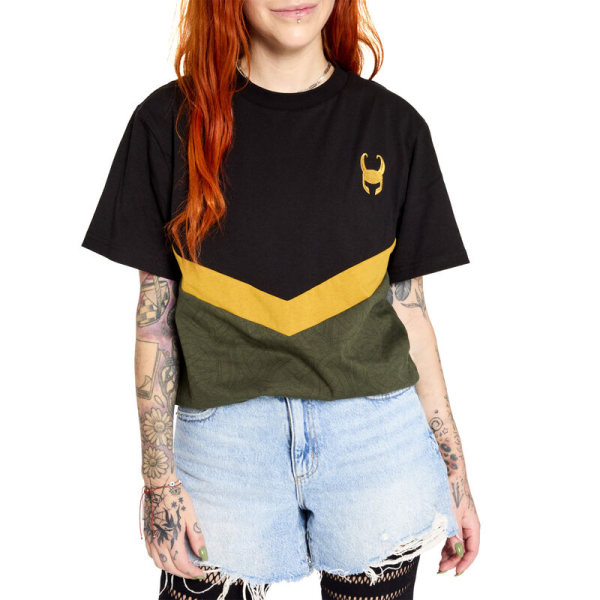 Slip away with a timeless look. The Loungefly COLLECTIV Marvel Loki The ORIGINL Tee offers a simple and versatile way to show off your fandom on any timeline. This classic tee features Loki’s helmet symbol as an embroidered detail, against a dark background. A chevron, in gold, divides color blocks where intricate patterns of Loki’s snake symbol repeat for an extra-subtle expression of your favorite fandom. The Loungefly COLLECTIV Marvel Loki the ORIGINL Tee is super soft and made of 100% cotton jersey. Additional features include seamed color blocking and embroidery. This tee is an officially licensed Marvel product.