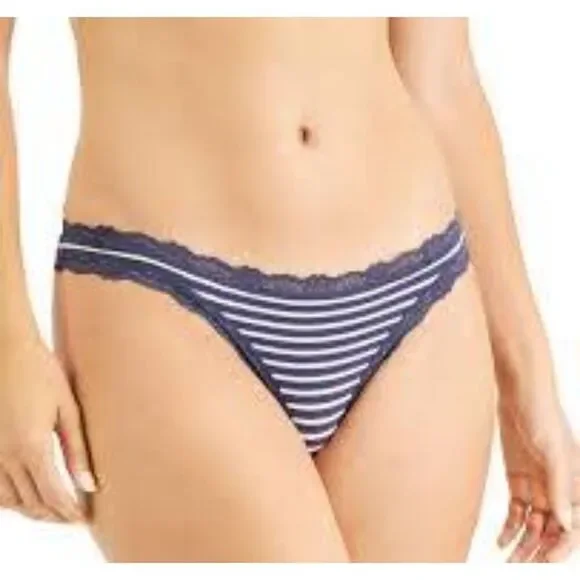 Indulge in both style and comfort with the Jenni Women's Lace-Trim Thong in Nairobi Stripe. This thong combines a chic striped pattern with delicate lace accents, offering a perfect blend of sophistication and allure for your lingerie collection. Features: Nairobi Stripe Pattern: The Nairobi stripe design adds a touch of modern elegance and visual interest, making it a stylish addition to your underwear drawer. Lace Trim: Delicate lace trim along the edges adds a feminine and romantic touch while ensuring a soft and gentle feel against the skin. Thong Cut: The thong design provides minimal coverage, making it ideal for wearing under fitted clothing to eliminate visible panty lines and achieve a seamless look. Soft Fabric: Crafted from a premium fabric blend, this thong offers a soft and comfortable feel against the skin, ensuring all-day comfort. Comfortable Waistband: The elastic waistband is designed for a secure and comfortable fit, allowing you to move freely throughout the day. Material: Body: 92% Cotton, 8% Spandex Lace: 88% Nylon, 12% Spandex Care Instructions: Machine wash cold with like colors Use only non-chlorine bleach when needed Tumble dry low Do not iron