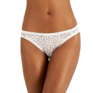 Unleash your wild side with the Jenni Women's Lace-Trim Thong in Pink Leo. This thong-style underwear combines a bold print with delicate lace details, offering a perfect mix of style and comfort for your lingerie collection. Features: Pink Leo Print: The vibrant pink leopard print adds a playful and fierce touch, making a bold statement in your underwear drawer. Lace Trim: Elegant lace trim along the edges adds a touch of femininity and sophistication while providing a soft and gentle feel against the skin. Thong Cut: The thong design offers minimal coverage, perfect for wearing under fitted clothing to eliminate visible panty lines and provide a smooth silhouette. Soft Fabric: Crafted from a high-quality fabric blend, this thong ensures a soft touch against the skin and excellent breathability, keeping you comfortable all day long. Comfortable Waistband: The elastic waistband is designed to stay in place without digging into the skin, offering a secure fit that moves with you. Material: Body: 92% Cotton, 8% Spandex Lace: 88% Nylon, 12% Spandex Care Instructions: Machine wash cold with like colors Use only non-chlorine bleach when needed Tumble dry low Do not iron