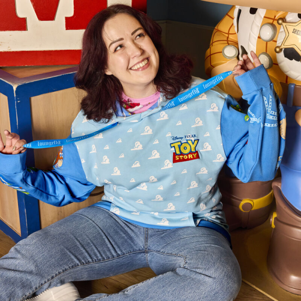 Round up your pals, it’s time to play! The Loungefly Toy Story Good Vs Baddies Unisex Hoodie brings together our favorite toys from the Disney-Pixar animated film. On the front, the clouds from Andy’s bedroom walls appear in an all-over print while the Toy Story logo appears above. Covering the sweatshirt’s sleeves, Andy’s toys gather together on one side while Sid’s toy creations appear on the other. The cloud design continues onto the back and hood of the sweater, and the hood has an inside lining of clouds, stars, and the Pixar ball. This cozy hoodie adds a playful element to any outfit and is the perfect wardrobe item for kids at heart. The Loungefly Toy Story Good Vs Baddies Unisex Hoodie is made of French Terry cotton (60% cotton, 40% polyester). Extra large lanyard-style drawcords add versatility in wear and fit and are perfect for displaying your favorite pins. Cuffs and waistband are 95% cotton and 5% Spandex. This hoodie is an officially licensed Disney-Pixar product. Comes in unisex sizes S through 3X.