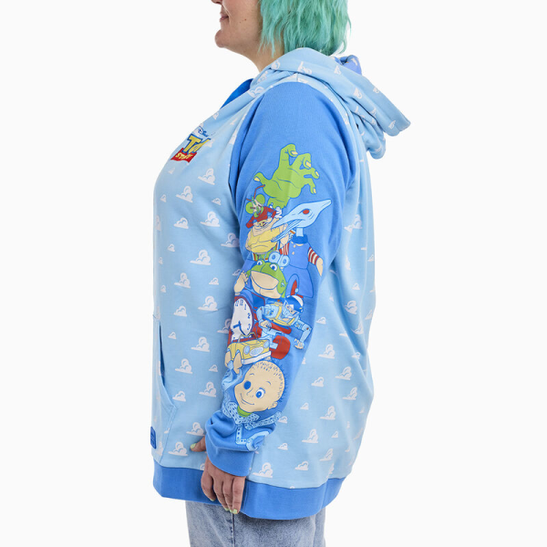 Round up your pals, it’s time to play! The Loungefly Toy Story Good Vs Baddies Unisex Hoodie brings together our favorite toys from the Disney-Pixar animated film. On the front, the clouds from Andy’s bedroom walls appear in an all-over print while the Toy Story logo appears above. Covering the sweatshirt’s sleeves, Andy’s toys gather together on one side while Sid’s toy creations appear on the other. The cloud design continues onto the back and hood of the sweater, and the hood has an inside lining of clouds, stars, and the Pixar ball. This cozy hoodie adds a playful element to any outfit and is the perfect wardrobe item for kids at heart. The Loungefly Toy Story Good Vs Baddies Unisex Hoodie is made of French Terry cotton (60% cotton, 40% polyester). Extra large lanyard-style drawcords add versatility in wear and fit and are perfect for displaying your favorite pins. Cuffs and waistband are 95% cotton and 5% Spandex. This hoodie is an officially licensed Disney-Pixar product. Comes in unisex sizes S through 3X.