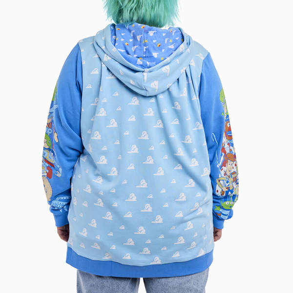 Round up your pals, it’s time to play! The Loungefly Toy Story Good Vs Baddies Unisex Hoodie brings together our favorite toys from the Disney-Pixar animated film. On the front, the clouds from Andy’s bedroom walls appear in an all-over print while the Toy Story logo appears above. Covering the sweatshirt’s sleeves, Andy’s toys gather together on one side while Sid’s toy creations appear on the other. The cloud design continues onto the back and hood of the sweater, and the hood has an inside lining of clouds, stars, and the Pixar ball. This cozy hoodie adds a playful element to any outfit and is the perfect wardrobe item for kids at heart. The Loungefly Toy Story Good Vs Baddies Unisex Hoodie is made of French Terry cotton (60% cotton, 40% polyester). Extra large lanyard-style drawcords add versatility in wear and fit and are perfect for displaying your favorite pins. Cuffs and waistband are 95% cotton and 5% Spandex. This hoodie is an officially licensed Disney-Pixar product. Comes in unisex sizes S through 3X.