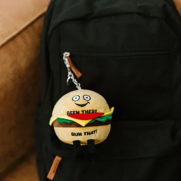 This burger has an aBUNdance of life experience. He’s been there, bun that, and is looking for his next big adventure. His playful eyes, happy smile, and 3D toppings make this bag charm un-bun-lievably cute. He’s got a calw clip, so you can easily hang him from your backpack or purse.