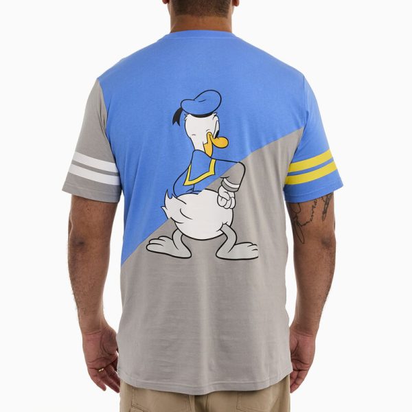 Head out to sea in great company! Gather your crew and set sail in style. This commemorative, crewneck, short-sleeved shirt features Disney’s Donald Duck in both grayscale and in color. The color scheme for this tee shirt splits on a diagonal so that the upper half of Donald Duck is in color, and the lower half is in grayscale. One sleeve carries a grayscale print with white stripes, and the other is in color, with yellow stripes. The artwork continues on the back, where you’ll encounter a tail-feathered view of Donald Duck in the same diagonal split of color and grayscale. Make waves while celebrating Donald Duck’s 90th anniversary in character. This tee features a screen print and is made of 100% cotton jersey. This tee is an officially licensed Disney product. Comes in unisex sizes S through 3X. Sizing is very specific, so please consult the size chart before purchasing.