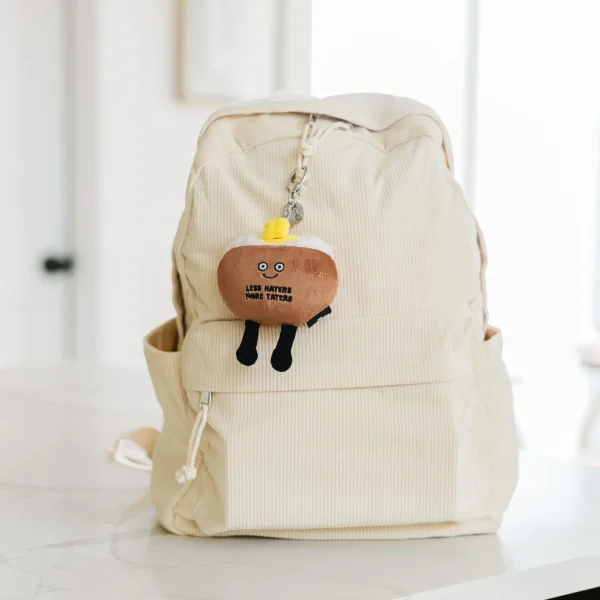 This little bag charm is a spud-tacular cheerleader. His supportive attitude makes him an ap-peel-ing accessory. With this tater, it’s all about the details. This charm’s fluffy tater top, small slab of butter, and tiny chive accents make him the perfect bite. He’d be a fun accessory for any bag or backpack.