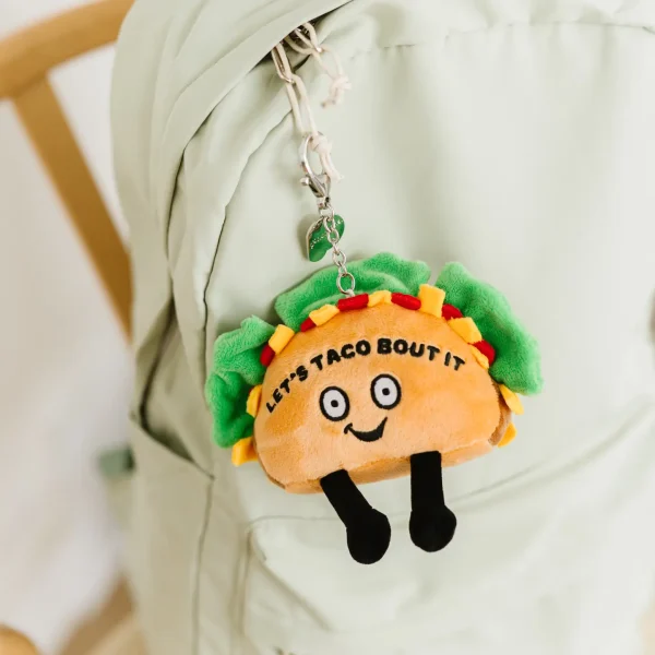 Lettuce taco ‘bout how cute this bag charm is! This bite-sized plushie is perfect for any taco lover. His fun smile, dangly legs, and 3D toppings make him simply irresistible. He’d make a spec-taco-lar addition to any backpack, purse, or wallet.