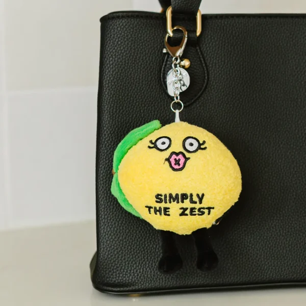 OMG! Citrusly? This bite thinks you’re simply the zest and wants you to juice be yourself. Her kissy face, leafy details, and dangly legs make her sweet, not sour. Hang her from your backpack or purse, and she’ll serve as a great reminder to always squeeze the day!