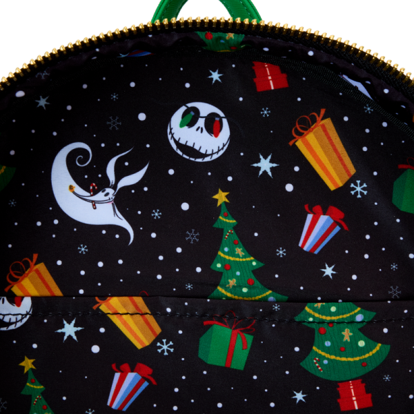 Up and down and ‘round we go! Jack and Sally take Christmas Town for a spin on this whimsical mini backpack. Slide the train back and forth to set things in motion, and turn down the lights to witness a glowing nighttime spectacular! This accessory makes a festive addition to any outfit and will inspire holiday spirit wherever you go. Features: Vegan leather (polyurethane) Adjustable shoulder straps Front zipper pocket Shiny gold hardware Applique, embossed, glow-in-the-dark, and printed details Coordinating inside lining Dimensions: 10.15”W x 12.5”H x 4”D This backpack is an officially licensed Disney product.