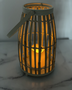 The Lark & Meadow 18" Bamboo Lantern with Candle in Whitewash is a beautiful decorative piece that brings a rustic yet elegant charm to any space. Crafted from bamboo and finished with a subtle whitewash, this lantern has a natural, airy look that complements a variety of décor styles. Inside the lantern is an LED candle, offering a warm, ambient glow without the worry of an open flame. Its 18-inch height makes it a perfect accent for both indoor and outdoor spaces, whether placed on a patio, by the fireplace, or as a centerpiece on a dining table. This lantern adds a cozy, inviting atmosphere to any setting.