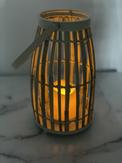 The Lark & Meadow 18" Bamboo Lantern with Candle in Whitewash is a beautiful decorative piece that brings a rustic yet elegant charm to any space. Crafted from bamboo and finished with a subtle whitewash, this lantern has a natural, airy look that complements a variety of décor styles. Inside the lantern is an LED candle, offering a warm, ambient glow without the worry of an open flame. Its 18-inch height makes it a perfect accent for both indoor and outdoor spaces, whether placed on a patio, by the fireplace, or as a centerpiece on a dining table. This lantern adds a cozy, inviting atmosphere to any setting.