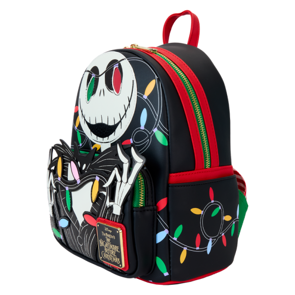 If your eyes light up at the thought of Christmas, this bag’s for you! Jack Skellington embraces the holiday spirit in a tangle of colorful lights. As daylight fades, you’ll see him glow in the dark while two of the lights illuminate with light-up details! This mini backpack makes a festive addition to any outfit and adds a bright spot to any holiday celebration. Features: Vegan leather (polyurethane) Adjustable shoulder straps with printed webbing Front zipper pocket Side drop pockets Shiny gold hardware Applique, embroidered, glow-in-the-dark, LED light, and printed details Coordinating inside lining Dimensions: 9”W x 10.5”H x 4.5”D This backpack is an officially licensed Disney product.