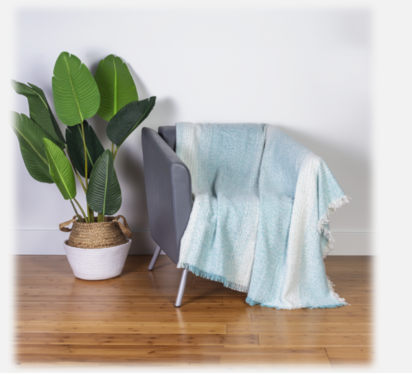 The Concierge Collection 50" x 60" Ombré Stripe Knit Throw in Aqua is a stylish and comfortable addition to any space, featuring a soft knit fabric with a beautiful ombré effect in calming aqua shades. The gradual color transition adds a touch of elegance, while the lightweight yet warm fabric makes it perfect for snuggling. Its generous size is ideal for draping over sofas, chairs, or beds, making it both a functional and decorative piece that complements various decor styles. This throw is a great way to add a fresh, modern look to your home.