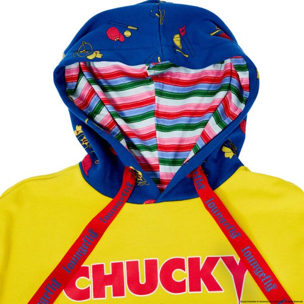 The Good Guy is ready to play up your look. Our Chucky Hooded Jersey, which resembles a Good Guys Chucky doll box, is full of frighteningly fun details. On the bright yellow middle portion, letters in red spell out “Chucky,” and the text below reads, “He wants YOU for a best friend.” It also appears that he’s ready to come out of the box, as he “slashes” a “knife” with a metallic applique blade through the clear “plastic window,” which is really a clear gel print. You’ll also see that the Chucky “box” includes pictures of the Good Guys accessories and a message to collect them all. The sleeves, similar in color to Chucky’s denim overalls, feature a motif of Good Guys accessories, such as cowboy hats, baseballs, and more. Head off to a memorable play date or other adventures in style. Features: French terry fabric: 60% cotton, 40% polyester; ribbing & cuffs: 95% cotton & 5% Spandex Side pockets Soft hand screen print, applique, and clear gel details Extra-large lanyard-style drawcord for displaying pins Lined jersey hood Comes in unisex sizes S through 3X. Sizing is very specific. This jersey is an officially licensed Universal City Studios product.