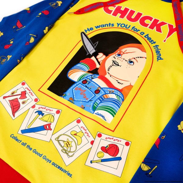 The Good Guy is ready to play up your look. Our Chucky Hooded Jersey, which resembles a Good Guys Chucky doll box, is full of frighteningly fun details. On the bright yellow middle portion, letters in red spell out “Chucky,” and the text below reads, “He wants YOU for a best friend.” It also appears that he’s ready to come out of the box, as he “slashes” a “knife” with a metallic applique blade through the clear “plastic window,” which is really a clear gel print. You’ll also see that the Chucky “box” includes pictures of the Good Guys accessories and a message to collect them all. The sleeves, similar in color to Chucky’s denim overalls, feature a motif of Good Guys accessories, such as cowboy hats, baseballs, and more. Head off to a memorable play date or other adventures in style. Features: French terry fabric: 60% cotton, 40% polyester; ribbing & cuffs: 95% cotton & 5% Spandex Side pockets Soft hand screen print, applique, and clear gel details Extra-large lanyard-style drawcord for displaying pins Lined jersey hood Comes in unisex sizes S through 3X. Sizing is very specific. This jersey is an officially licensed Universal City Studios product.