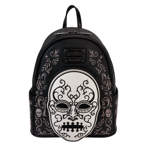 Heading to Malfoy Manor for an important meeting? Do so in style with our Harry Potter™ Death Eater Mini Backpack. This wickedly fashionable accessory features an oval-shaped front pocket with a Death Eater’s face that comes to life in applique, silver metallic vegan leather, and embroidered detail. Elegant flourishes appear on the main part of the backpack, just behind the front pocket, and they continue on the side panels. On one side panel, you will find the image of a serpent, and on the other, a skull. Turn the backpack around, and the incantation for conjuring up the Dark Mark appears: “Morsmordre.” Pack your potions, wand—or daily essentials—and take off on magical adventures in character. Features: Vegan leather (polyurethane) Padded, adjustable shoulder straps with faux snakeskin textured details Side pockets Zippered main compartment for securing items Zippered front compartment for storing smaller items Black metal hardware Applique, metallic vegan leather, embroidered, and printed details Coordinating inside lining Dimensions: 9”W x 10.5”H x 4.5”D This backpack is an officially licensed Warner Bros. product.