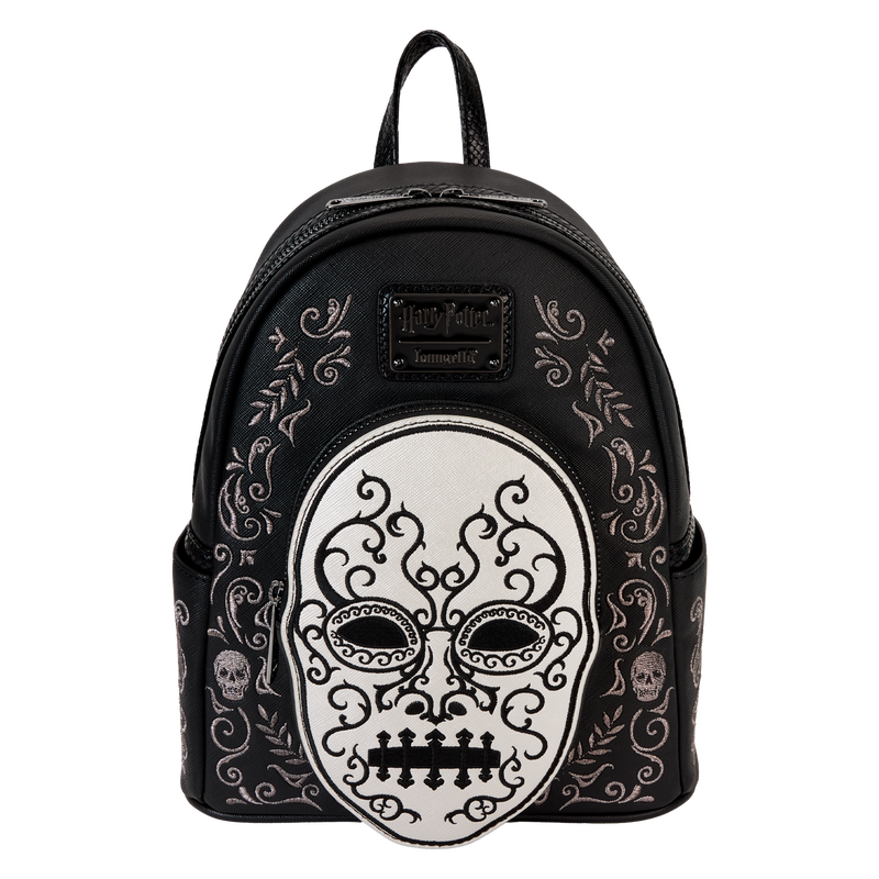 Heading to Malfoy Manor for an important meeting? Do so in style with our Harry Potter™ Death Eater Mini Backpack. This wickedly fashionable accessory features an oval-shaped front pocket with a Death Eater’s face that comes to life in applique, silver metallic vegan leather, and embroidered detail. Elegant flourishes appear on the main part of the backpack, just behind the front pocket, and they continue on the side panels. On one side panel, you will find the image of a serpent, and on the other, a skull. Turn the backpack around, and the incantation for conjuring up the Dark Mark appears: “Morsmordre.” Pack your potions, wand—or daily essentials—and take off on magical adventures in character. Features: Vegan leather (polyurethane) Padded, adjustable shoulder straps with faux snakeskin textured details Side pockets Zippered main compartment for securing items Zippered front compartment for storing smaller items Black metal hardware Applique, metallic vegan leather, embroidered, and printed details Coordinating inside lining Dimensions: 9”W x 10.5”H x 4.5”D This backpack is an officially licensed Warner Bros. product.