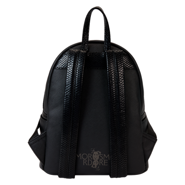 Heading to Malfoy Manor for an important meeting? Do so in style with our Harry Potter™ Death Eater Mini Backpack. This wickedly fashionable accessory features an oval-shaped front pocket with a Death Eater’s face that comes to life in applique, silver metallic vegan leather, and embroidered detail. Elegant flourishes appear on the main part of the backpack, just behind the front pocket, and they continue on the side panels. On one side panel, you will find the image of a serpent, and on the other, a skull. Turn the backpack around, and the incantation for conjuring up the Dark Mark appears: “Morsmordre.” Pack your potions, wand—or daily essentials—and take off on magical adventures in character. Features: Vegan leather (polyurethane) Padded, adjustable shoulder straps with faux snakeskin textured details Side pockets Zippered main compartment for securing items Zippered front compartment for storing smaller items Black metal hardware Applique, metallic vegan leather, embroidered, and printed details Coordinating inside lining Dimensions: 9”W x 10.5”H x 4.5”D This backpack is an officially licensed Warner Bros. product.