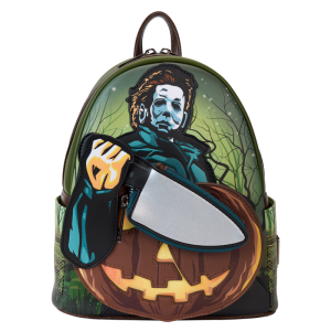 Crash the haunted hayride party looking sharp. Bring along our Halloween Mini Backpack. This accessory features Michael Myers in eerie applique detail, his form rising up over the front pocket. The front pocket is shaped like a jack-o’-lantern, and Michael Myers brandishes a knife with a reflective metallic vegan leather “blade.” This applique knife doubles as a removable coin bag for storing smaller items on your journeys. In the dark, the jack-o’-lantern’s eyes and mouth glow! The gleaming knife makes an encore appearance as a print on the back. Pack your daily essentials and stalk your favorite haunts in style. Features: Vegan leather (polyurethane) in dark green with brown trim Padded, adjustable shoulder straps in dark brown Side pockets with artwork of dark branches, grass, and barbed wire Zippered main compartment for securing items Zippered front compartment for storing smaller items Removable coin purse Gunmetal-colored hardware Applique, glow-in-the-dark, reflective metallic vegan leather, and printed details Coordinating inside lining Dimensions: 9”W x 10.5”H x 4.5”D This backpack is an officially licensed Compass International Pictures product.