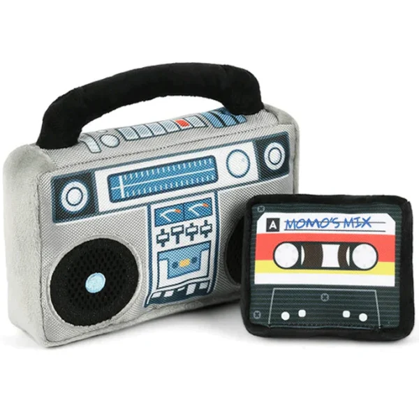 The P.L.A.Y. Grey Boombox Dog Toy is a retro-inspired, plush toy designed to resemble a classic boombox, bringing a fun, nostalgic vibe to your dog's playtime. Made with soft, durable fabric, this toy features embroidered details like buttons and speakers to mimic a real boombox. It includes engaging elements like squeakers and crinkling sounds, making it perfect for interactive play and keeping your dog entertained. Ideal for dogs who love plush toys with a bit of noise, the Grey Boombox Dog Toy adds a playful, vintage twist to your dog's toy collection, combining both style and fun.