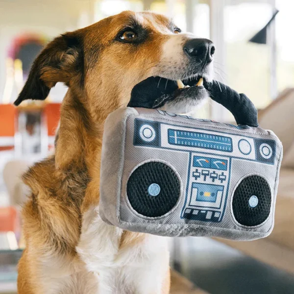 The P.L.A.Y. Grey Boombox Dog Toy is a retro-inspired, plush toy designed to resemble a classic boombox, bringing a fun, nostalgic vibe to your dog's playtime. Made with soft, durable fabric, this toy features embroidered details like buttons and speakers to mimic a real boombox. It includes engaging elements like squeakers and crinkling sounds, making it perfect for interactive play and keeping your dog entertained. Ideal for dogs who love plush toys with a bit of noise, the Grey Boombox Dog Toy adds a playful, vintage twist to your dog's toy collection, combining both style and fun.