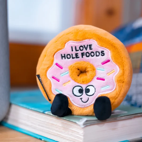 This plushie loves whole foods and thinks others should too! Donut worry though, this little guy also enjoys bagels, swiss cheese, onion rings, tortellini¦Well, you get the picture. His sweet smile, dangly legs, and 3D sprinkle details make him irresistible. He's an a-glaz-ing gift for any donut lover. This plush is ideal for children, collectors, or anyone who loves cozy and fun decor.