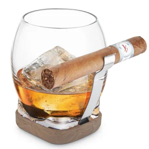 Our whiskey glass with cigar grip makes the experience even better by letting you hold your drink and cigar with one hand at the same time. Simply fill with your favourite beverage, then slide a cigar into the fully adjustable cigar grip. The cigar when inserted is held above the whiskey liquid level, which helps to prevent condensation from absorbing into the cigar. Additionally, the silicone base doubles as a non-slip coaster and the cigar grip can be removed for enjoyment without a cigar! Built-In Cigar Grip - Stainless steel grip holds the cigar securely in place by using tension and is fully adaptable to accommodate most sizes of cigars. Whiskey Glass - Uniquely shaped round bowl to help enhance aromas with a thick square glass base that provides a balanced & comfortable hand-feel while drinking. Silicone base with wood design protects surfaces from scratches & dents. Top lip of the stainless steel cigar grip is rounded off to help prevent tearing of the cigar while inserting and removing. Elevated Grip Position - Designed to hold the cigar above the whiskey liquid level, which helps to prevent condensation from absorbing into the cigar. Ideal for cigars 42-60 ring gauge size: 42 gauge: 0.66" (16.54 mm) dia.| 60 gauge: 0.94" (23.62 mm) dia. Use with and without the cigar grip.