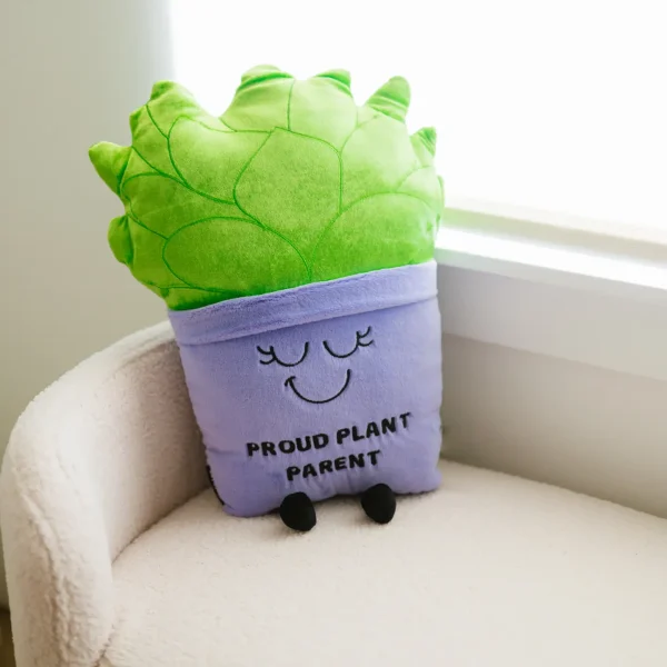 This Puffie pillow is perfect for any proud plant parent. You keep plants alive, and everyone deserves to know it! We see you. You grow, girl! We be-leaf in you! (And if youâ€™re not the best plant parent, at least you know you canâ€™t kill this one.) This oversized plushieâ€™s sweet smile, leafy detail, and popping planter make it a plantastic accessory for any home or office. This plush is ideal for children, collectors, or anyone who loves cozy and fun dÃ©cor. A great addition to gift shops and toy stores!