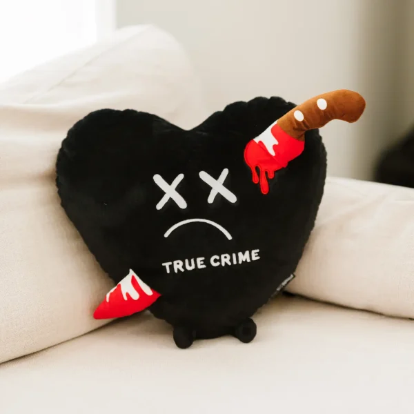 Calling all true crime, girlies! You NEED this Puffie pillow! With this oversized plushie (and like any murder mystery), the attention is all in the details. The lifeless expression and bloody knife make this item a must-have for any true crime lover. It's the perfect pillow to snuggle up with while you binge your favorite true crime podcast and try to figure out who the murderer is (even though we all know the husband did it). This plush is ideal for children, collectors, or anyone who loves cozy and fun decor.