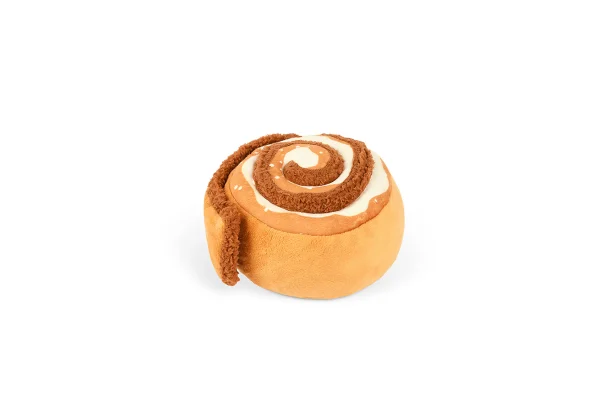 P.L.A.Y.'s Pup Cup Café Cinna-bone toy is a cinnamon roll delight that features a squeaker in the body for an extra dash of excitement with a crinkly bottom. In addition, the crinkles in the unraveling layer make playtime even more engaging, providing everlasting fun. Treat your pup to the irresistible charm, where every play session is a delectable adventure! Hand-made craftsmanship, double layer exterior and reinforced stitching for extra durability Eco-friendly PlanetFill® filler is made from 100% post-consumer certified-safe recycled plastic bottles Machine washable and dryer friendly Features AZO-free dyes