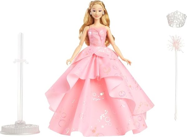 Inspired by Universal Pictures' Wicked, the deluxe Glinda doll captures her signature look from the musical film! Embellished bold, statement earrings, Glinda wears her voluminous, ruffled pink ballgown with iridescent foil bubble details that complete her magical look! The Good Witch doll accents her outfit with her wand and tiara! With true-to-movie looks and long blonde hair perfectly styled in curls, Glinda doll charms with a true-to-movie look! Clip Glinda doll onto the doll stand and create dramatic poses with 11 points of articulation! Highlighting the beauty of sisterhood and friendship, Wicked dolls make an inspiring gift for kids to play out their biggest dreams! Fans can collect their favorite Wicked characters to recreate scenes and make up their own storylines and adventures.