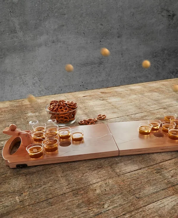 Studio bring on the party games with Studio Mercantile wooden mini beer pong drinking game set. The built-in ball catapult adds additional fun to the class beer pong game. Wooden board folds up for easy storage and for taking the party on the go.