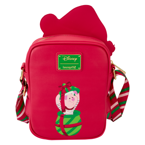 Hang the lights and pass the honey! Our Disney’s Winnie the Pooh Crossbuddies™ bag is a festively sweet way to celebrate the holidays in style. Winnie the Pooh is all decked out in a Santa hat and beard. His applique hands hug a detachable, reversible coin bag, which you can fill with a sweet treat or two. On one side, you’ll find an applique print of Disney’s Piglet, and on the other side, you’ll discover a printed applique of a beautifully wrapped honey pot gift. Piglet even makes an encore appearance as a print, inside a jar of honey. Make the season even sweeter with this fun accessory. Features: Vegan leather (polyurethane) Adjustable shoulder straps with a candy-cane striped print Detachable, reversible coin purse Gold-colored metal hardware Applique and printed details Coordinating inside lining Dimensions: 6.25”W x 8.25”H x 2.25”D