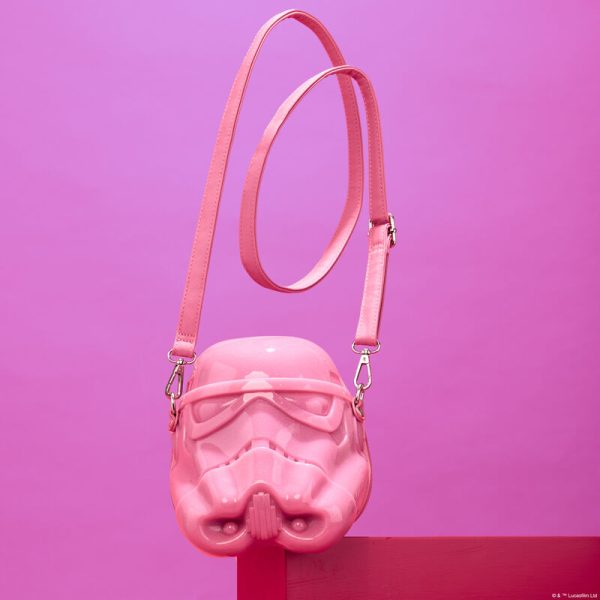 Best dressed member of the galaxy? It’s you, of course! This crossbody bag channels the dark side and gives it a makeover with glittery details to highlight the stormtrooper’s helmet. This accessory makes a stellar addition to any outfit and is perfect for fans looking for a fresh take on their favorite space opera. Features: Molded silicone bag Adjustable (detachable) shoulder strap Glitter and printed details Coordinating inside lining Dimensions: 6.5”W x 7.25”H x 5.7”D This bag is an officially licensed STAR WARS™ product.