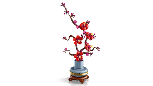 Take time out with the LEGO® Icons Plum Blossom (10369) flower decor building set for adults. The plum blossom is a popular motif in traditional art, often portrayed in ink-and-wash paintings as part of a classic quartet of beautiful plants known as the Four Gentlemen. Indulge in a mindful building project or treat a loved one to this timeless floral display – a perfect gift idea for any occasion. This detailed replica captures the elegance of the iconic winter flora with its woody stem and vivid red and magenta flowers. Set in a pastel-blue flowerpot with a golden band and wood-effect plinth, it is easy to assemble, delivers a rewarding building experience and makes a beautiful, easy-care flower display for the home and office. Discover a space for relaxation with buildable models from the LEGO Botanical Collection, part of the inspiring range of LEGO building sets designed for adults. A digital version of the building instructions is available in the LEGO Builder app. Flower decor building set for adults – Take time out or join friends and family for a relaxing building experience with the LEGO® Icons Plum Blossom flower building project Creative building for plant-lovers – This creative building set includes everything you need to craft a plum blossom flower and a pastel-blue pot with a golden band and wood-effect plinth Detailed LEGO® flower set for new and experienced builders – This LEGO interpretation of a plum blossom plant comes with an elegant woody stem and vivid red and magenta flowers Easy-care flower display for the home or office – Add a self-sufficient splash of color to any space with this buildable, zero-maintenance floral display A mindful home decor gift idea – The LEGO® Icons Plum Blossom building set makes a great birthday or any-day gift idea for adult fans of LEGO building sets and flora Includes digital building instructions – The LEGO® Builder app features a digital version of the building instructions included with this set Part of the LEGO® Botanical Collection – Discover a space for relaxation with the wide range of LEGO construction sets designed specifically for adults Dimensions –The plum blossom flower, including the plant pot and plinth in this 327-piece building set, measures over 13.5 in. (34 cm) high, 6.5 in. (17 cm) wide and 3.5 in. (9 cm) deep