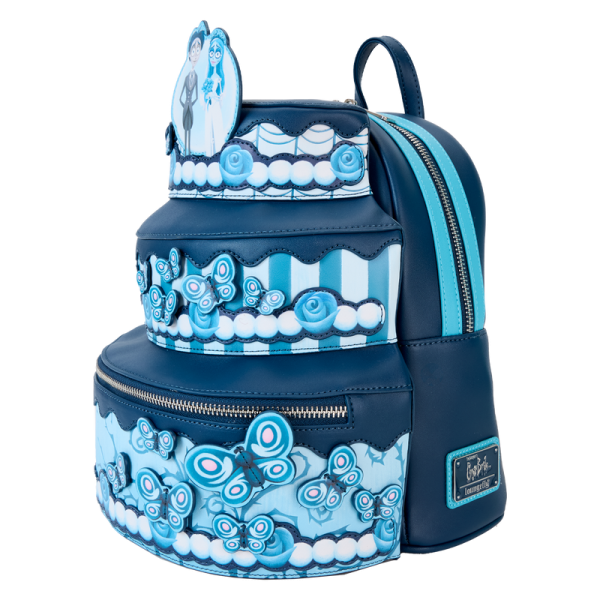 Give a toast to the bride and gloom! This three-tiered mini backpack recreates a wedding cake for Victor and Emily. Look closely and you’ll find motifs from the Land of the Dead hidden in the frosted details, including butterflies, roses, and Scraps the dog! This accessory makes a romantic addition to any outfit and will keep your belongings safe throughout your journey. Features: Vegan leather (polyurethane) Adjustable shoulder straps Front zipper pocket Side drop pockets Shiny silver hardware Applique, debossed, and printed details Coordinating inside lining Dimensions: 9”W x 10.5”H x 8”D This backpack is an officially licensed Corpse Bride™ product.